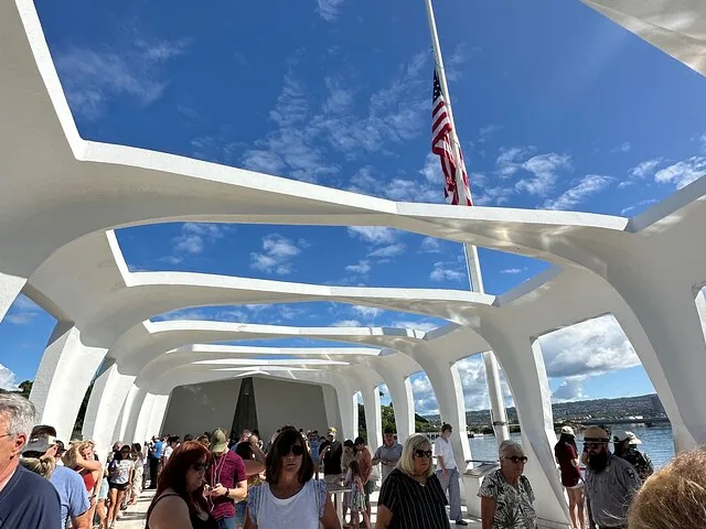 Crowd of visitors inside the open-air structure of the USS Arizona Memorial