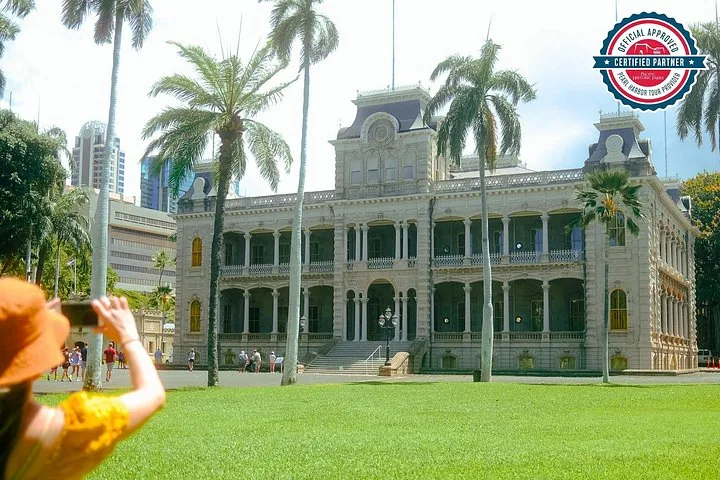 Person taking a photo of the historic Iolani Palace building